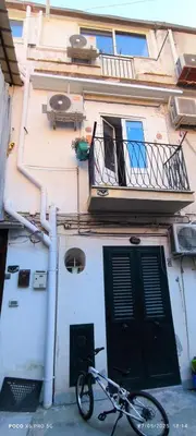 a bike parked in front of a building with a door at La Riali in Palermo