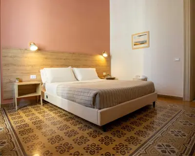 a bedroom with a large bed with a wooden headboard at Expa in Palermo