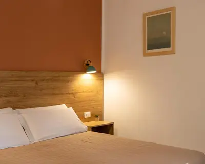 a bedroom with a bed with a wooden headboard at Expa in Palermo