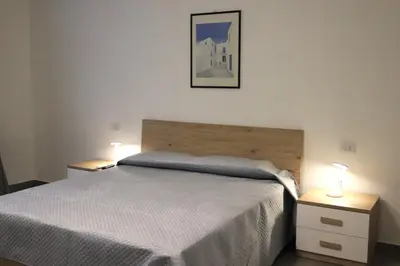 a bedroom with a bed and two lights on tables at Appartamenti Marì 1 in Palermo