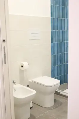 a bathroom with a toilet and a sink at Appartamenti Marì 1 in Palermo