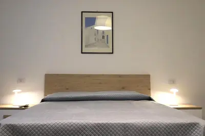 a bedroom with a bed with two lamps on tables at Appartamenti Marì 1 in Palermo