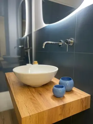 a bathroom with a bowl sink on a wooden table at Donna Franca in Cinisi