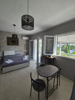 a bedroom with a bed and a table and chairs at Chalet Ponte Paradiso Suite & SPA in Santa Cristina Gela