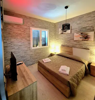 a bedroom with a bed and a tv in it at Chalet Ponte Paradiso Suite & SPA in Santa Cristina Gela