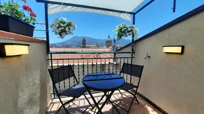 a patio with a table and chairs on a balcony at Oltre i Canti in Palermo