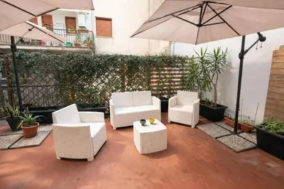 a living room with a yellow coffee table and a flat screen tv at Casa & Putia in Palermo