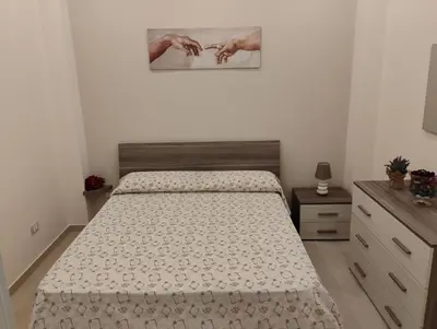 a bedroom with a bed and a picture on the wall at Casa dalla Zia Maria in Capaci