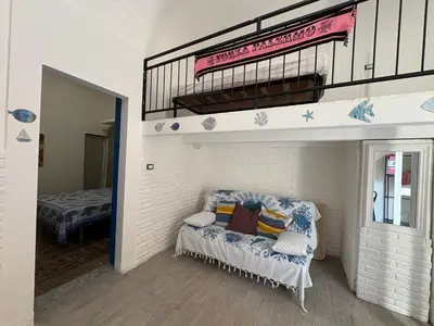a room with a bench under a bunk bed at Casa Ciccina in Palermo