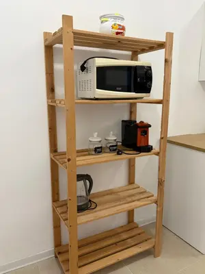 a wooden shelf with a microwave and a toaster oven at Casa Ciccina in Palermo
