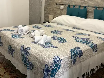 a blue and white bed with towels on it at Casa Ciccina in Palermo