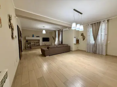 a large living room with a couch and a television at Infinity Home in Palermo