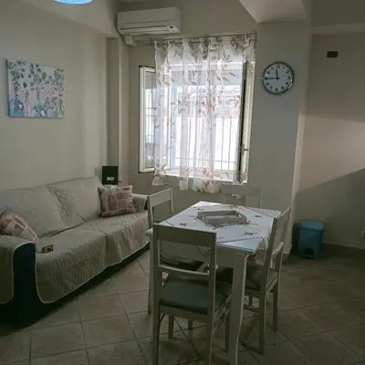 a living room with a table and a couch at Stella del mare in Palermo