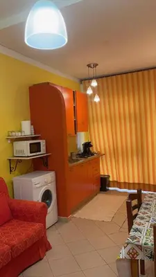 a kitchen with a washing machine in a room at Monolocale Signorile in Castellammare del Golfo