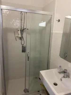 a bathroom with a glass shower and a sink at I Carrubi in Lascari