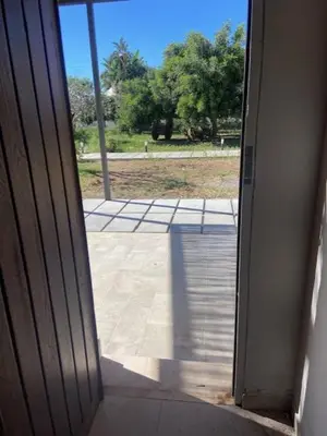 an open door with a view of a patio at I Carrubi in Lascari