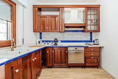 a kitchen with wooden cabinets and a sink at Domus Rosae in Palermo