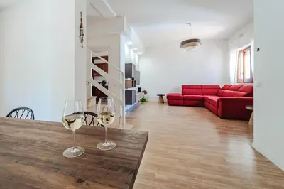 two wine glasses sitting on a wooden table in a living room at Domus Rosae in Palermo