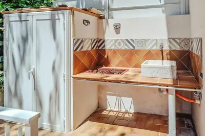 a kitchen with a stove and a refrigerator at Domus Rosae in Palermo