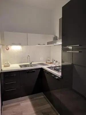 a kitchen with a sink and a stove at A casa della Vero in Palermo
