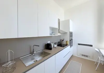 a kitchen with white cabinets and a sink at Solemar Sicilia - Villa Regina Elena in Palermo