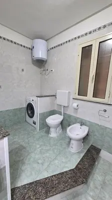 a bathroom with a toilet and a microwave at The brothers house appartamento alla Zisa in Palermo