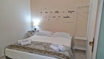 a bedroom with a bed with two towels on it at The brothers house appartamento alla Zisa in Palermo