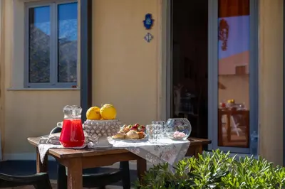 a table with fruit and wine glasses on it at Appartamenti da Lulù in San Vito lo Capo