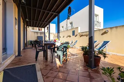a patio with a table and chairs on a balcony at Appartamenti da Lulù in San Vito lo Capo