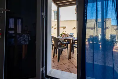 a view of a dining room table from a glass door at Appartamenti da Lulù in San Vito lo Capo
