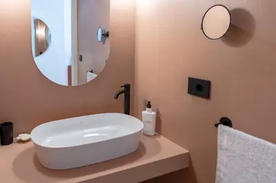 a bathroom with a white sink and a mirror at Pupa Ru Capu in Palermo