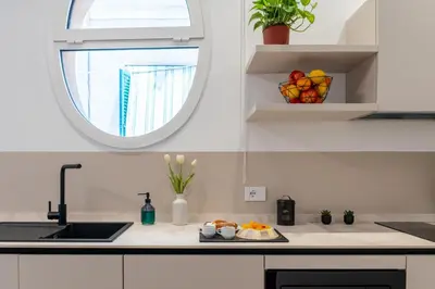 a kitchen counter with a sink and a window at Pupa Ru Capu in Palermo