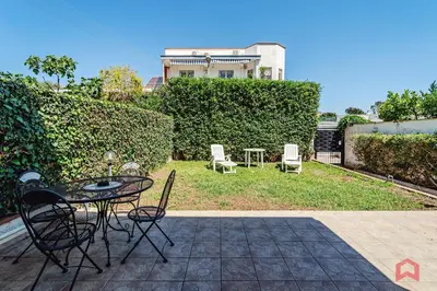 a patio with a table and chairs and a house at Charming Holiday Home in Palermo in Palermo