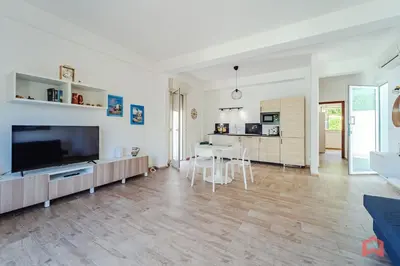 a living room with a large television and a table at Charming Holiday Home in Palermo in Palermo