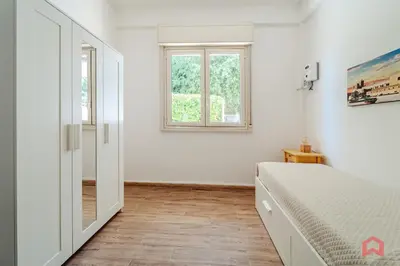 a white bedroom with a bed and a window at Charming Holiday Home in Palermo in Palermo