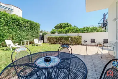 a patio with a table and chairs in a yard at Charming Holiday Home in Palermo in Palermo