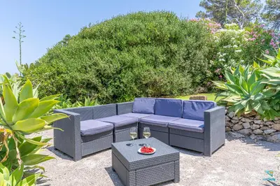 a patio with a blue couch and a table at Verosicily Villa Aspra in Bagheria