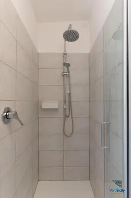 a bathroom with a shower with a glass door at Verosicily Villa Aspra in Bagheria