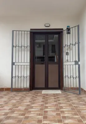 an entrance to a building with a wooden door at Appartamento Cinisi in Cinisi