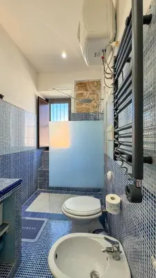 a bathroom with a toilet and a sink at Appartamento Cinisi in Cinisi