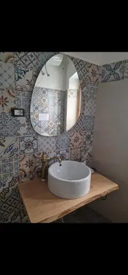 a bathroom with a white sink and a mirror at Marea in Palermo