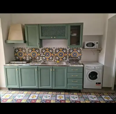 a kitchen with green cabinets and a washing machine at Marea in Palermo