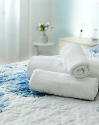 a stack of towels sitting on a bed at Brezza Di Mare Palermo in Palermo