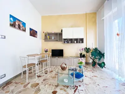 a living room with a table and a dining room at Brezza Di Mare Palermo in Palermo
