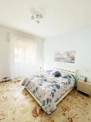 a bedroom with a bed in a white room at Brezza Di Mare Palermo in Palermo