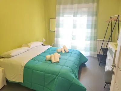 a green bedroom with a bed and a window at Guest House Conca D'oro in Palermo