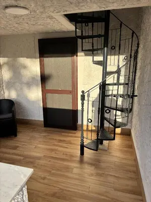 a spiral staircase in a room with a door at Valley Casale in Belmonte Mezzagno