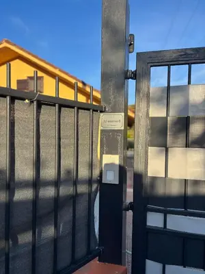 a gate with a parking meter next to a fence at Valley Casale in Belmonte Mezzagno