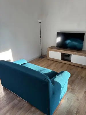 a blue couch in a living room with a tv at Valley Casale in Belmonte Mezzagno