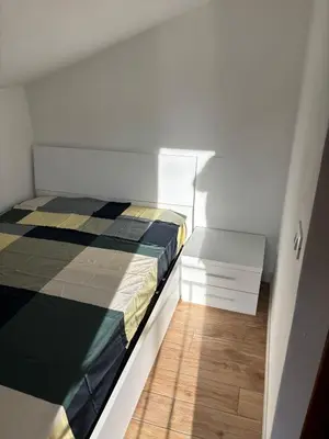 a small bedroom with a bed and a wooden floor at Valley Casale in Belmonte Mezzagno